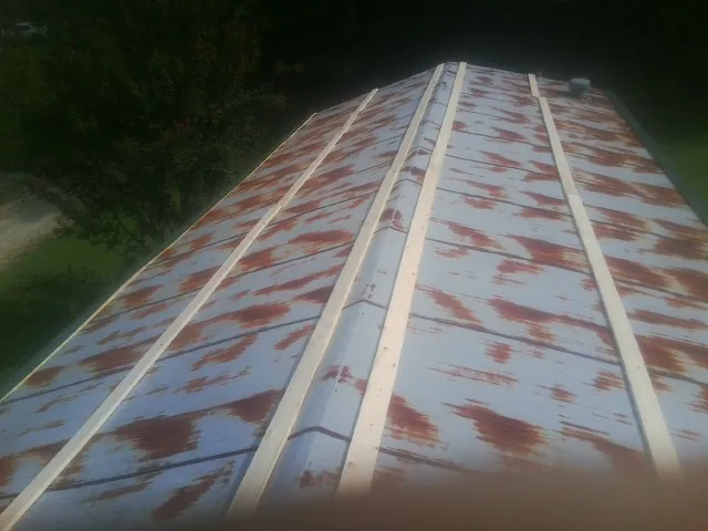 Rusted metal roof panels with new wood purlins before replacement — Storm Damage Roof Repair in La Honda by Roofing Brothers