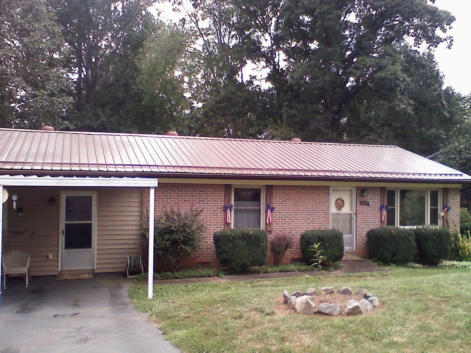 Bronze metal roof and carport on a brick ranch home — Roof Repair work by our crew in La Honda